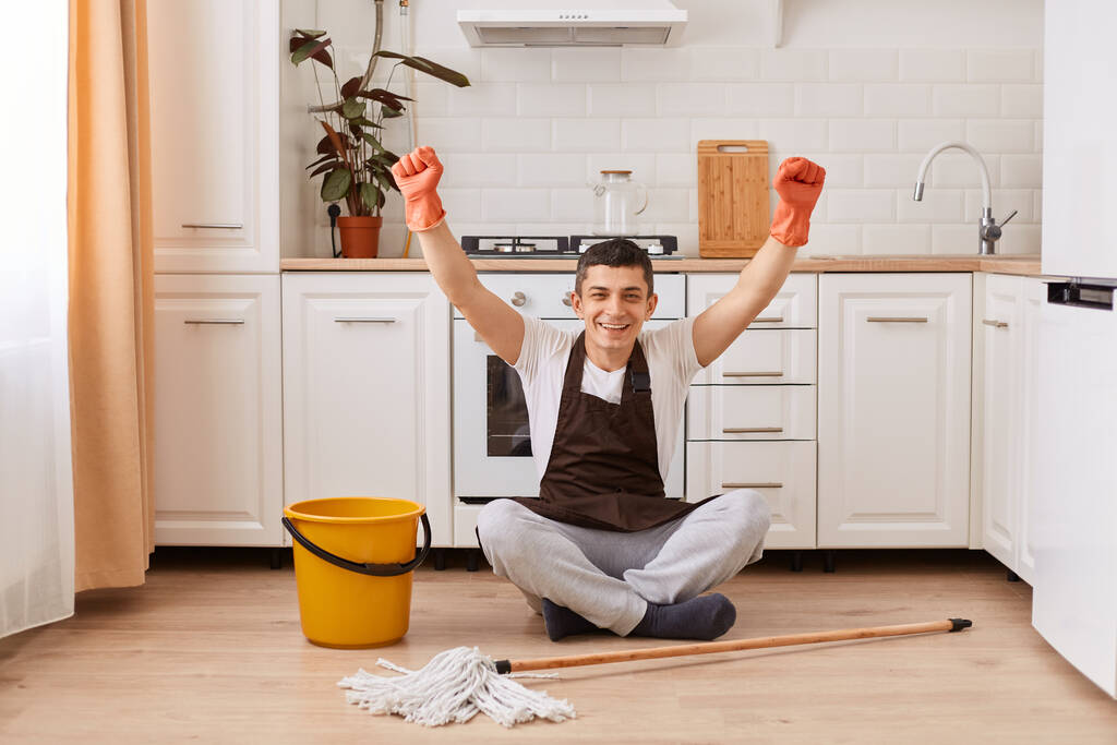 Stock Photo Full Length Portrait Happy Handsome Man Sitting Floor Kitchen Clenched